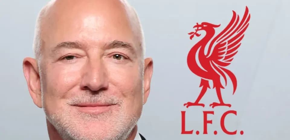 Man in tuxedo next to Liverpool FC logo