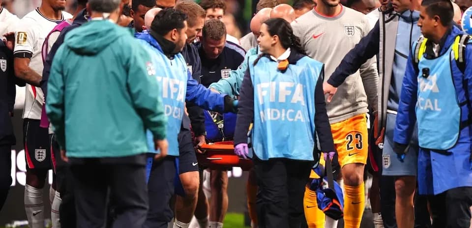 Medical staff assisting injured player off the field