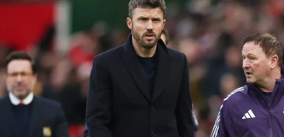 Men in suits walking on the pitch during match