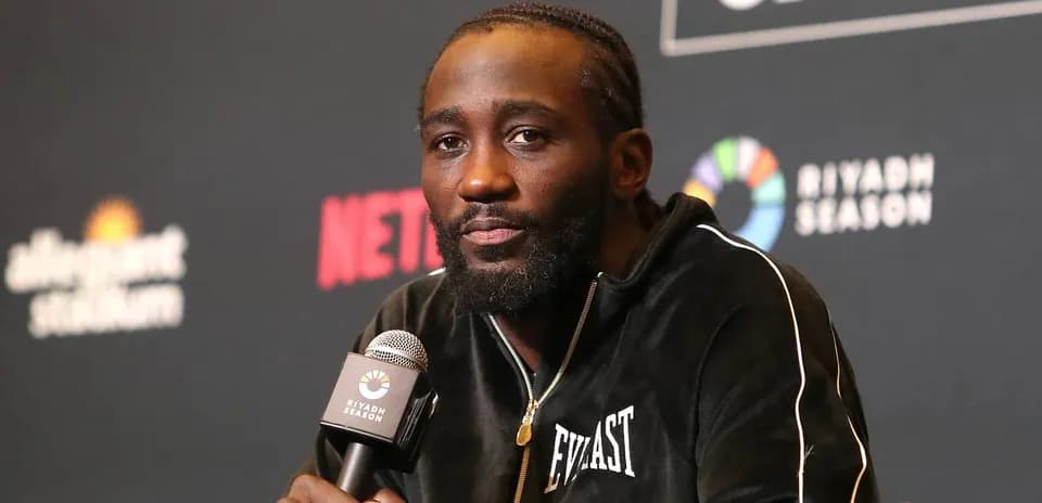 Boxer speaking at a press conference with microphone