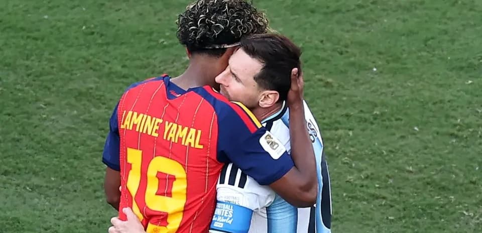 Two football players embracing on the field