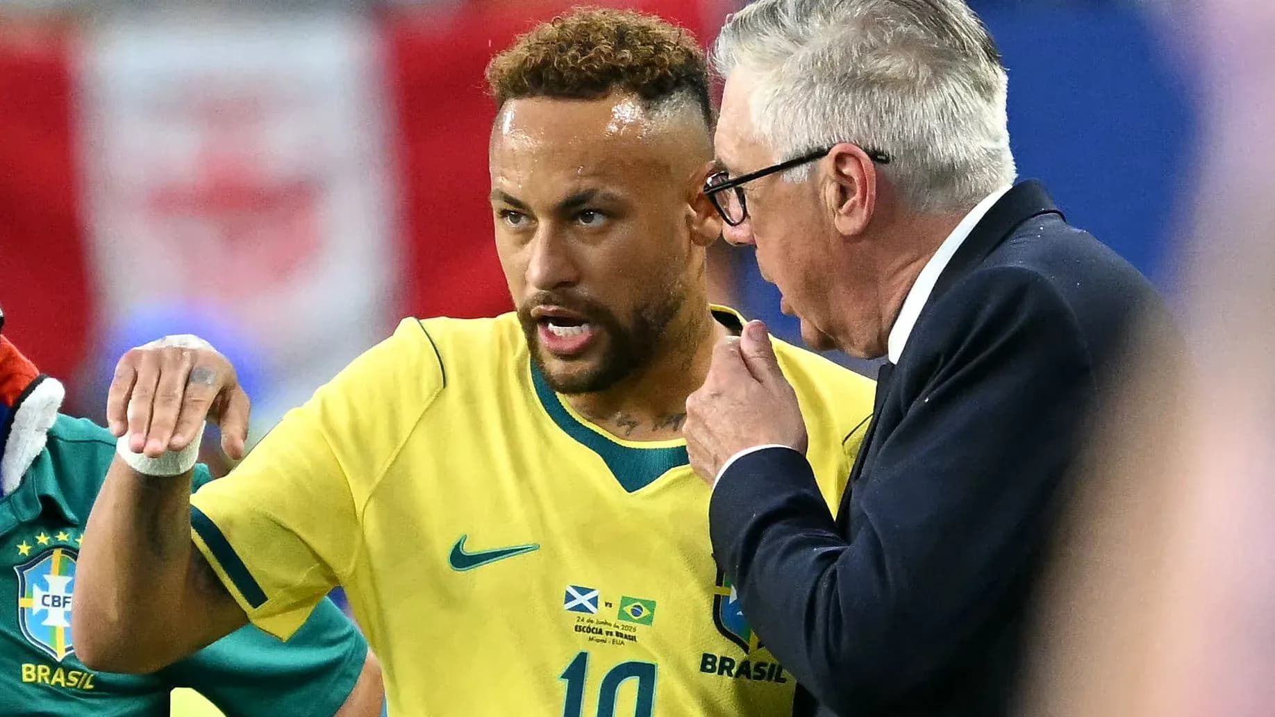 Neymar discussing strategy with coach during match