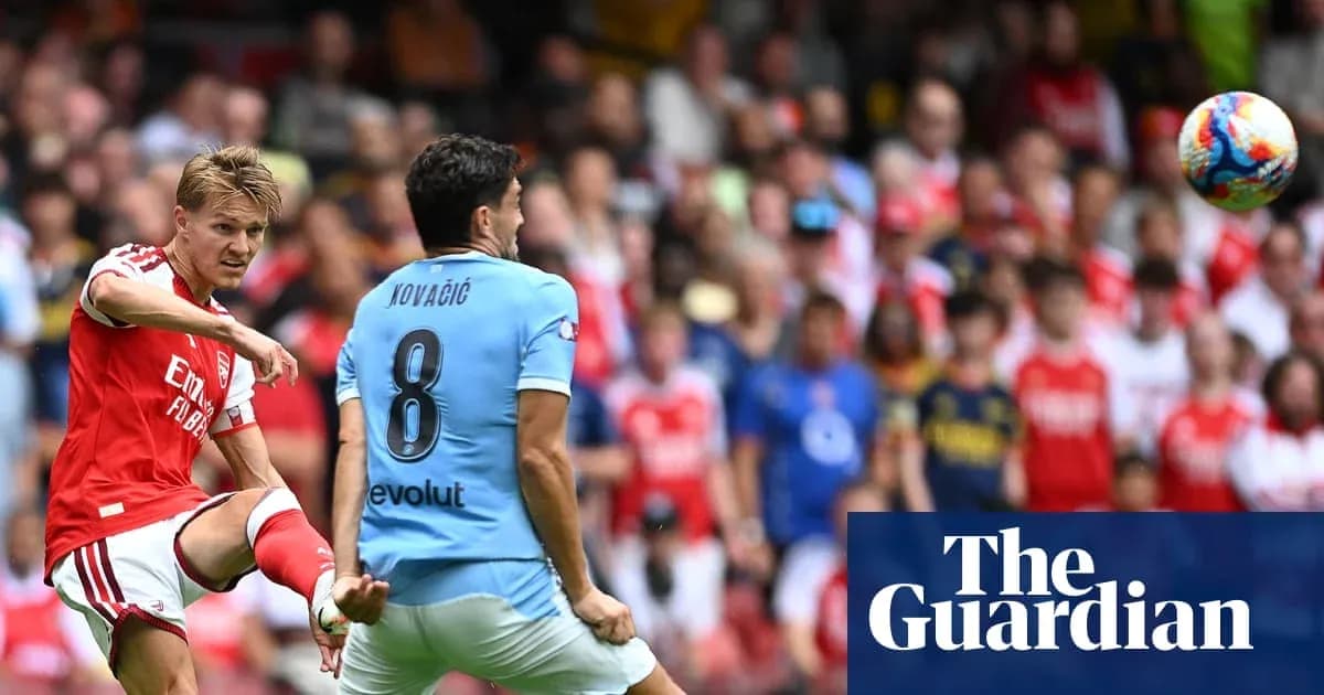 Arsenal player kicking ball towards Kovacic during match