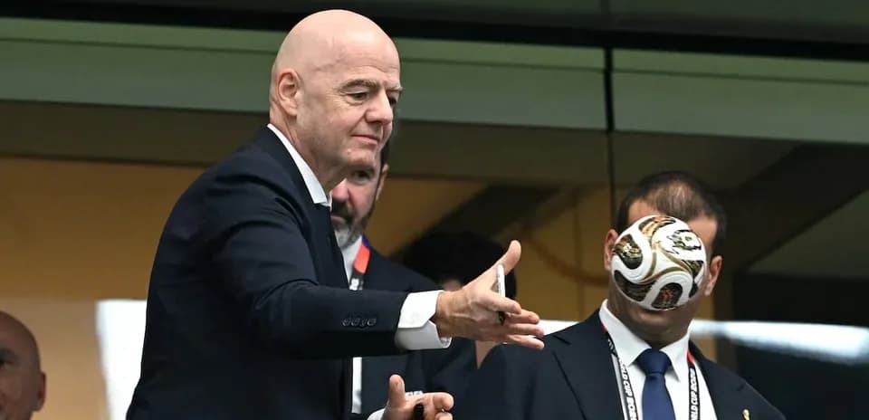 FIFA president tossing a football in VIP box