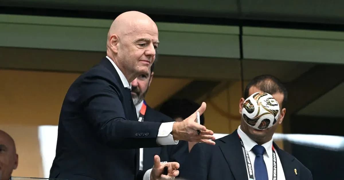 FIFA president tossing a football in VIP box