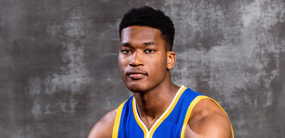 Basketball player in team jersey posing for portrait
