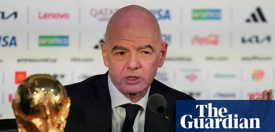 FIFA president speaking at press conference with trophy