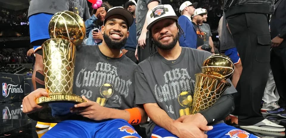 Two players celebrating with championship trophies