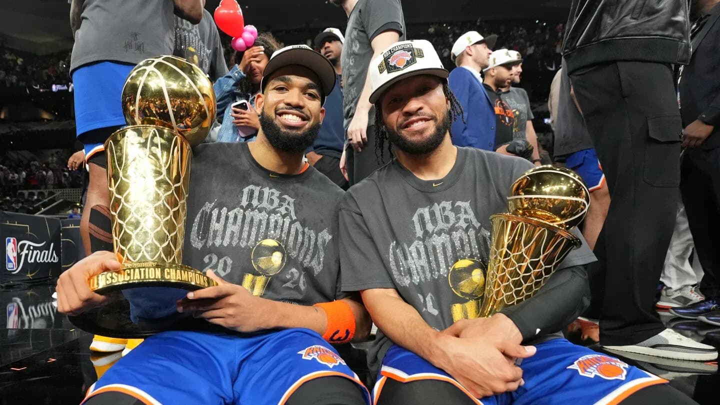 Two players celebrating with championship trophies