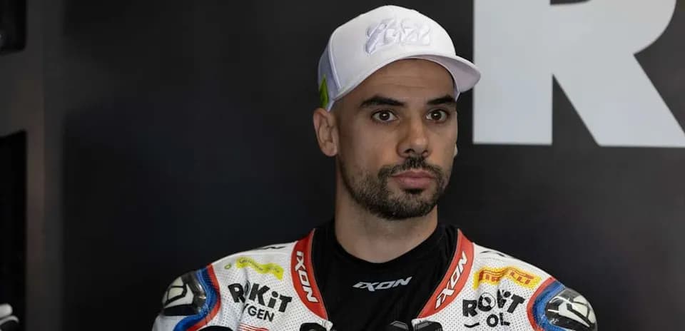 Motorsport rider in racing suit and cap