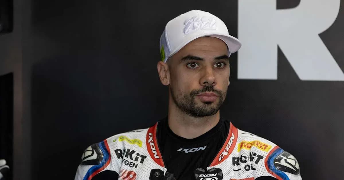 Motorsport rider in racing suit and cap
