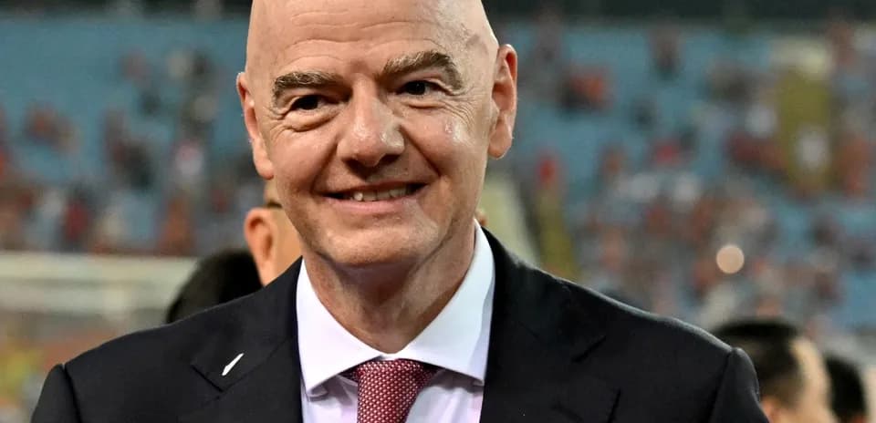 FIFA president smiling at a football event