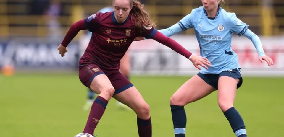 Two players competing for the ball during match