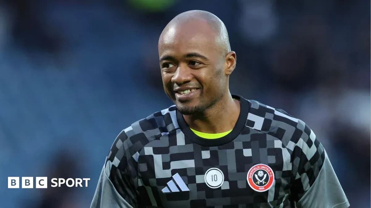 Goalkeeper in Sheffield United kit smiling on pitch