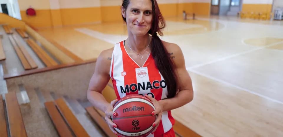 Basketball player in Monaco jersey holding ball