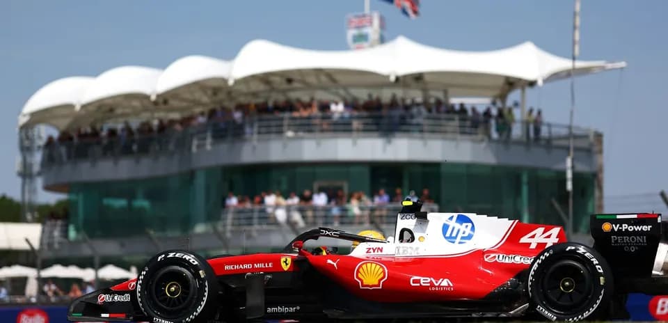 F1 car racing past grandstand during event