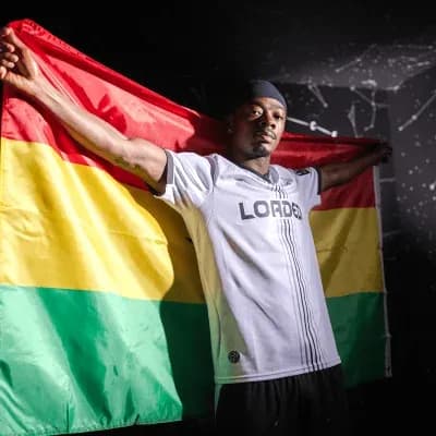Player holding Bolivian flag in sports jersey