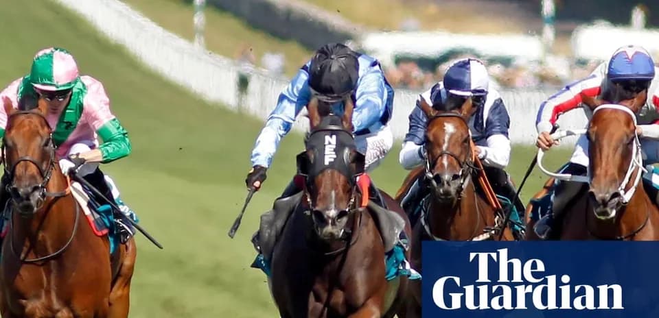 Jockeys racing horses on a turf track
