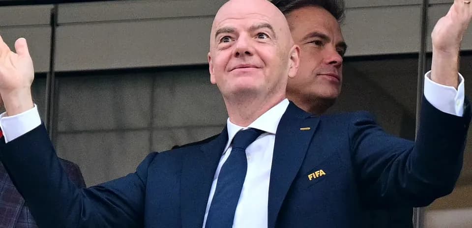 FIFA official gesturing from VIP box at event
