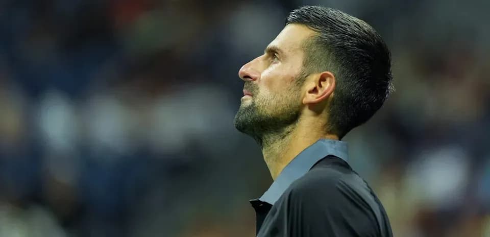 Tennis player looking upwards during match