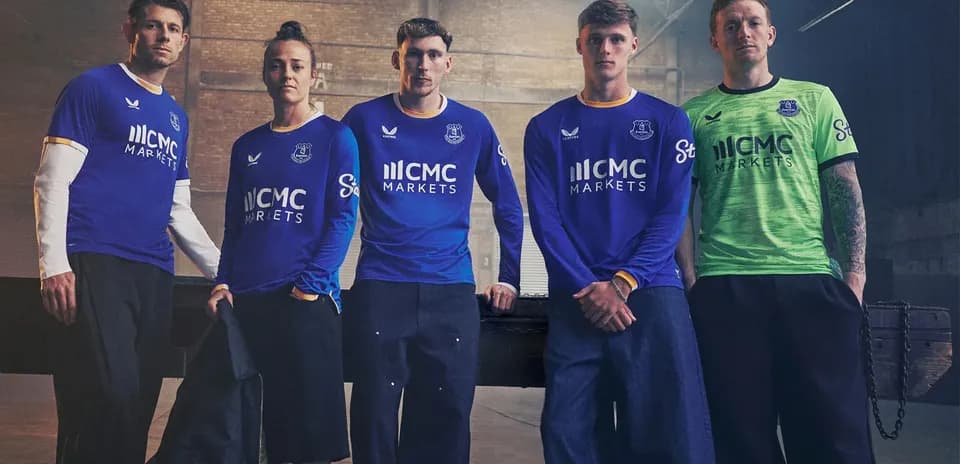 Everton players posing in team jerseys and kit