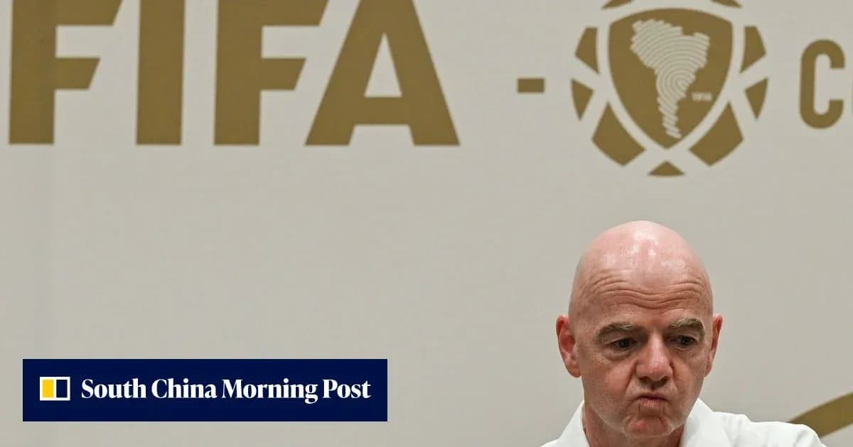 FIFA official at press conference with logo backdrop
