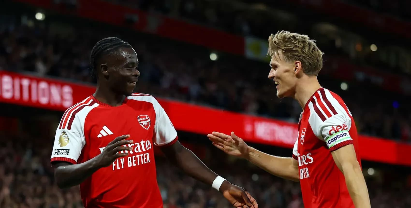 Arsenal players celebrating a goal on the pitch