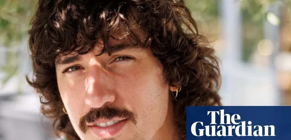 Yoshinobu Yamamoto posing with curly hair