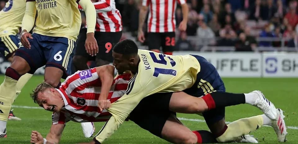 Players battling for the ball on the ground