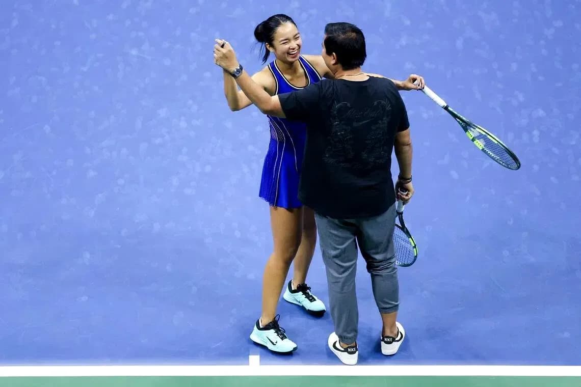 Tennis player celebrating with coach on court