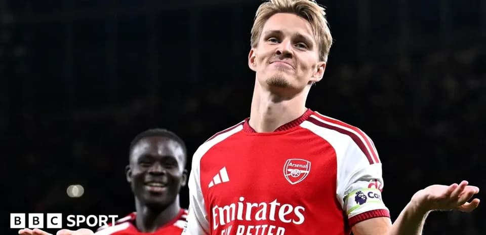 Arsenal player celebrating with teammate after goal