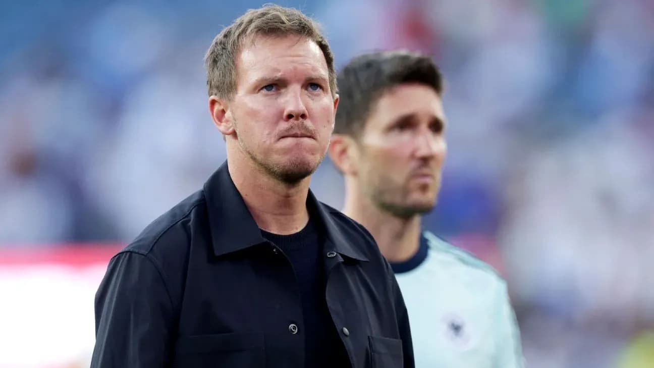 Two coaches standing on the sidelines before match