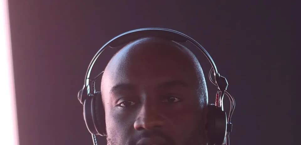 Man wearing headphones in a dimly lit setting