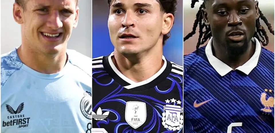 Three football players in team kits during match