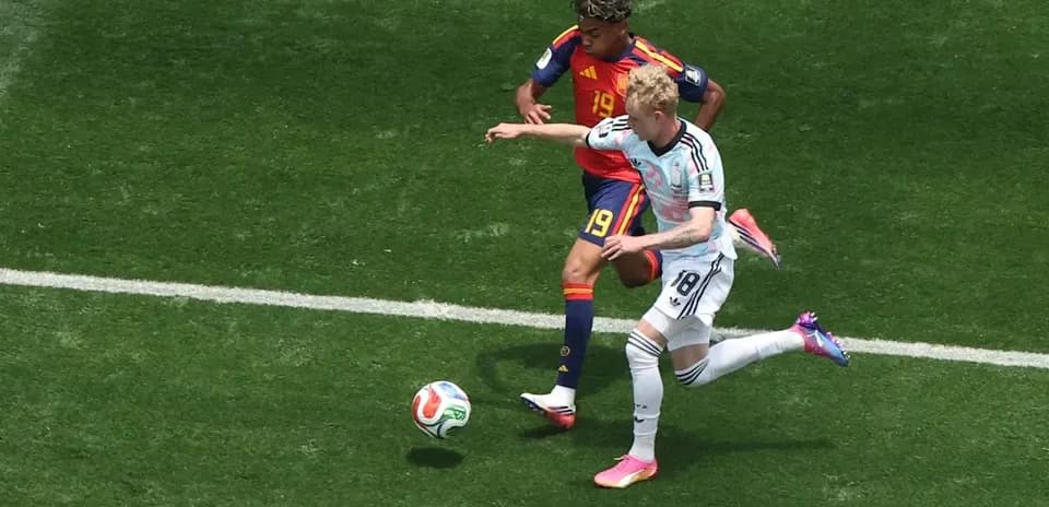 Two players contesting for the ball on field