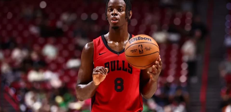 Basketball player holding ball during game warm-up