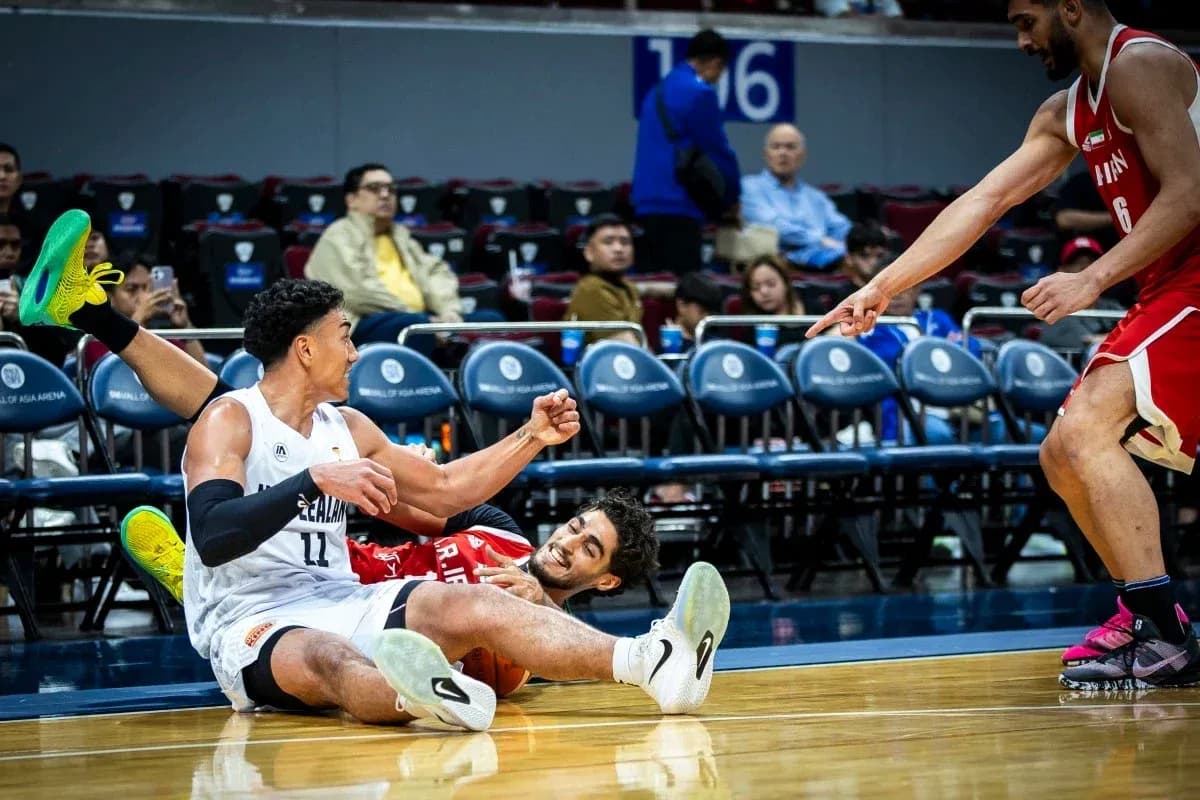 Two players on the floor battling for the ball