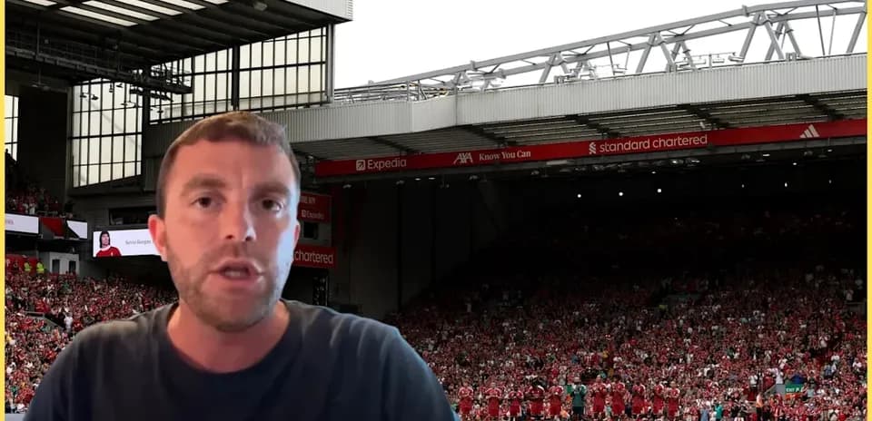 Analyst speaking in front of Anfield stadium crowd