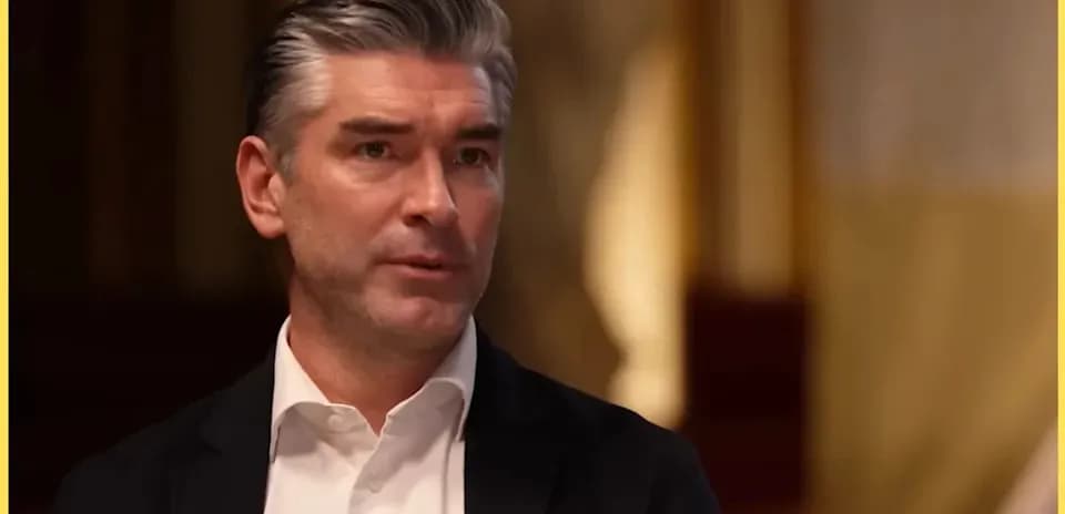 Man speaking during an interview in formal setting