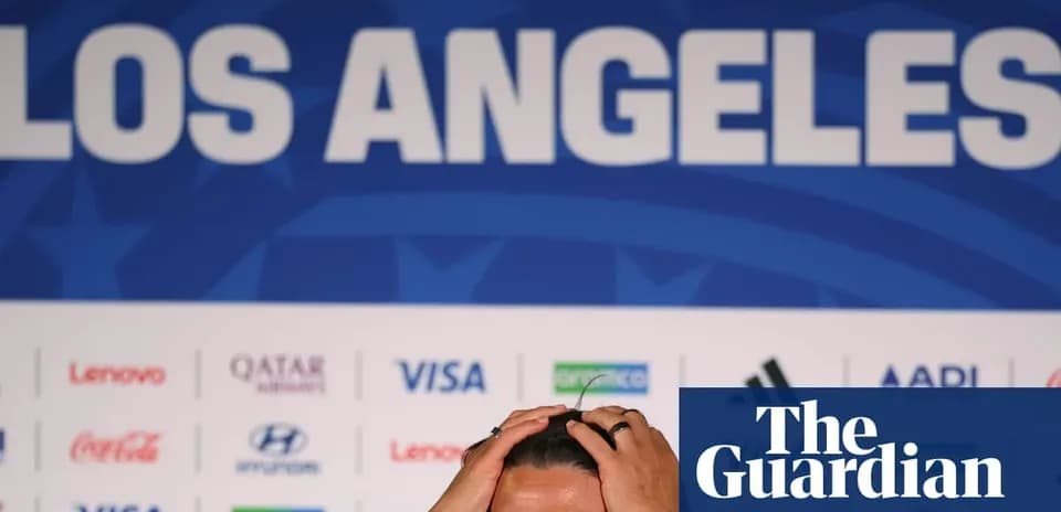 Shirtless player holding head at press conference