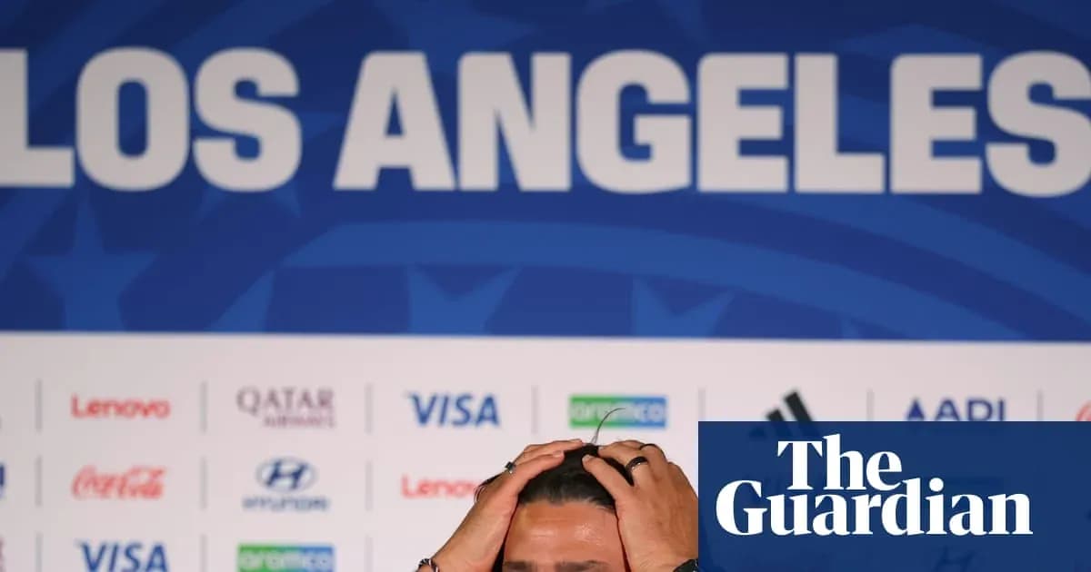 Shirtless player holding head at press conference