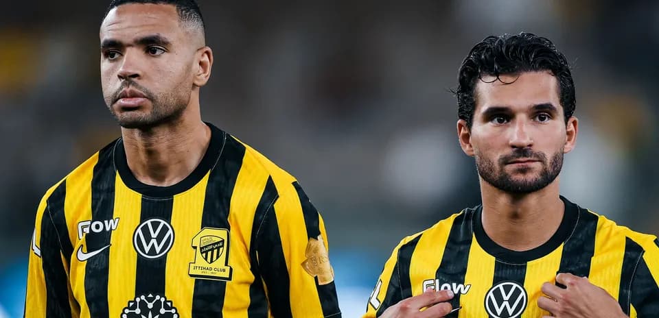 Ittihad Club players in yellow and black jerseys