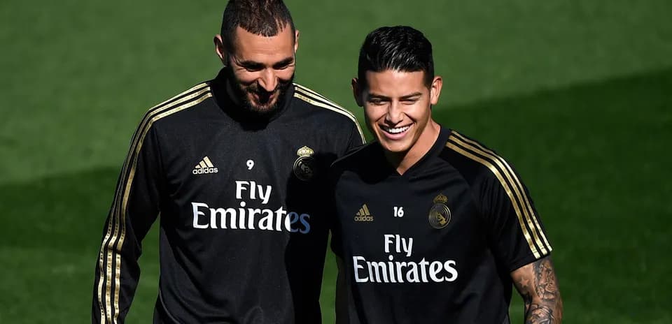 Karim Benzema and James Rodríguez smiling during training