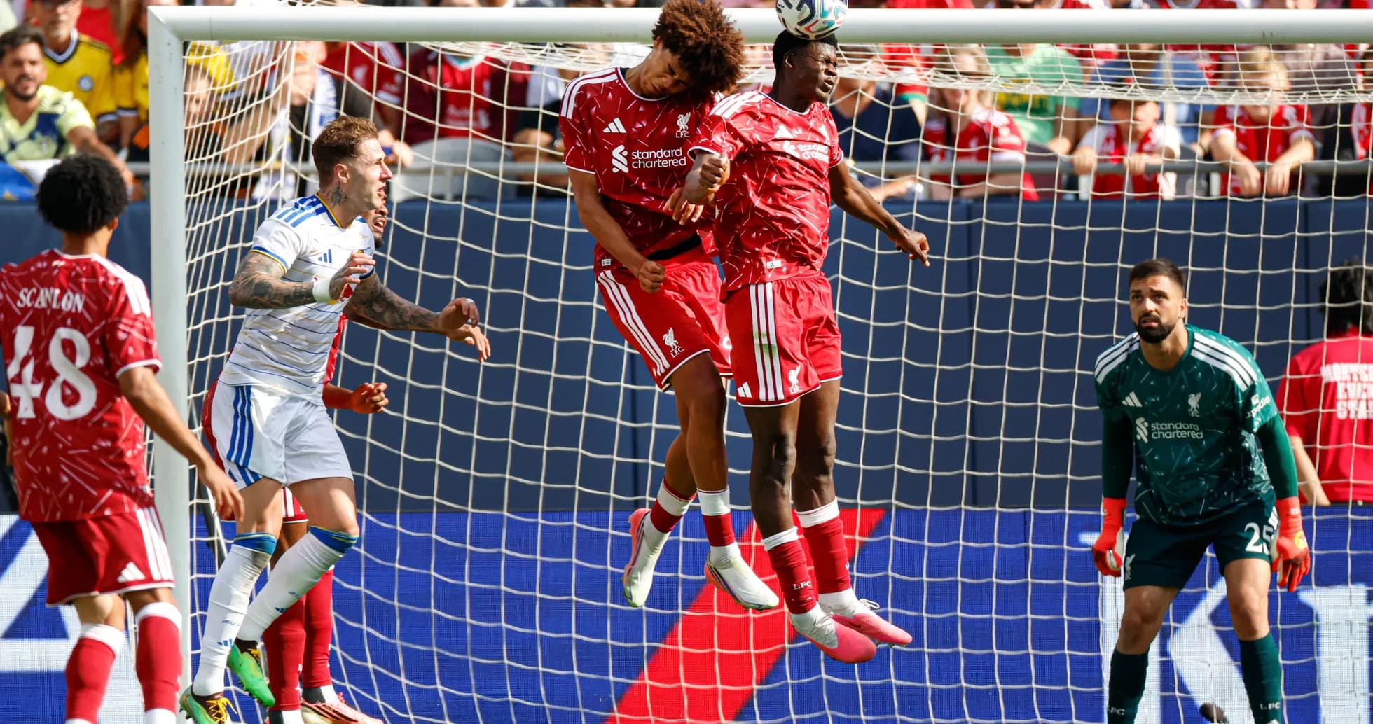 Liverpool players jumping to contest a header