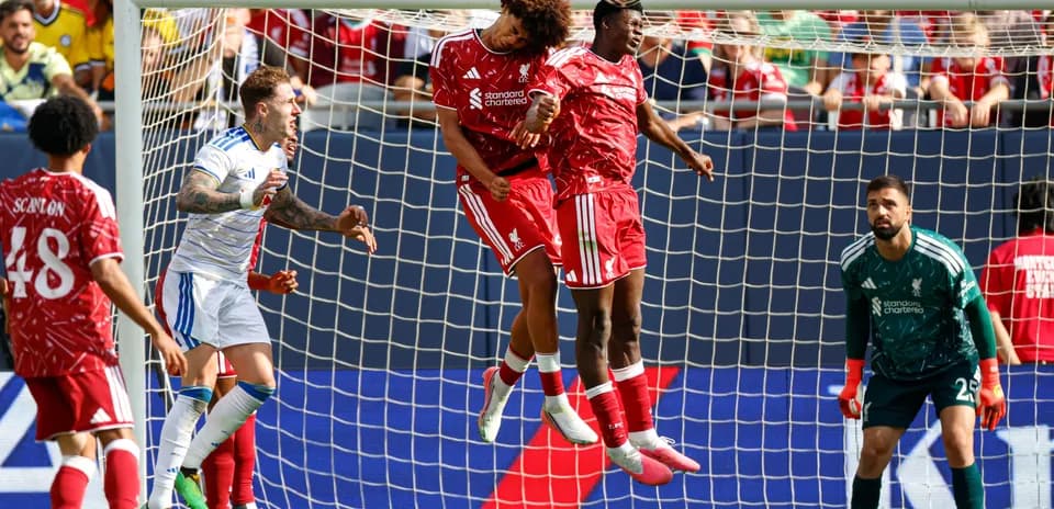 Liverpool players jumping to contest a header
