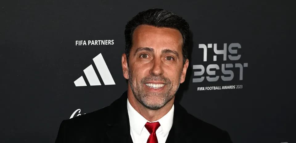 Man smiling at FIFA Football Awards 2023 backdrop