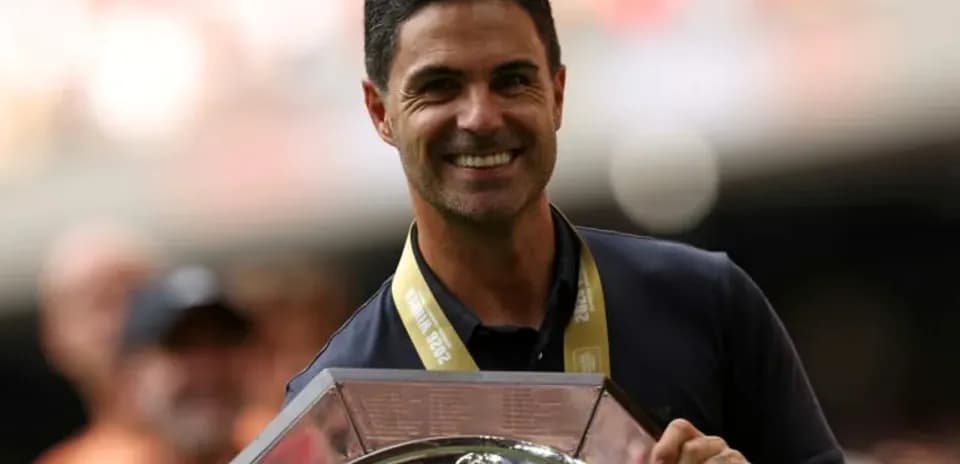 Men coach holding trophy during celebration event