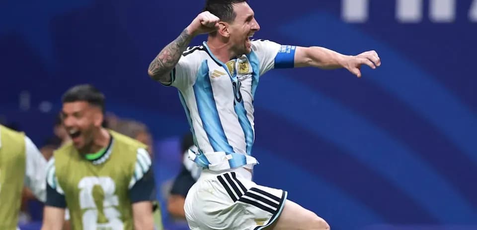 Messi celebrating a goal with teammates in background