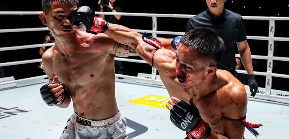 Two fighters exchanging punches in boxing ring