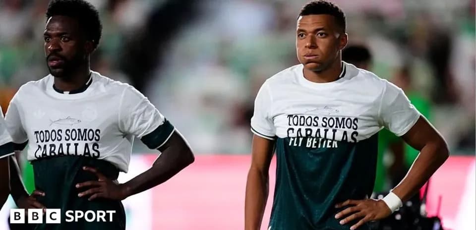 Two players in warm-up shirts before match